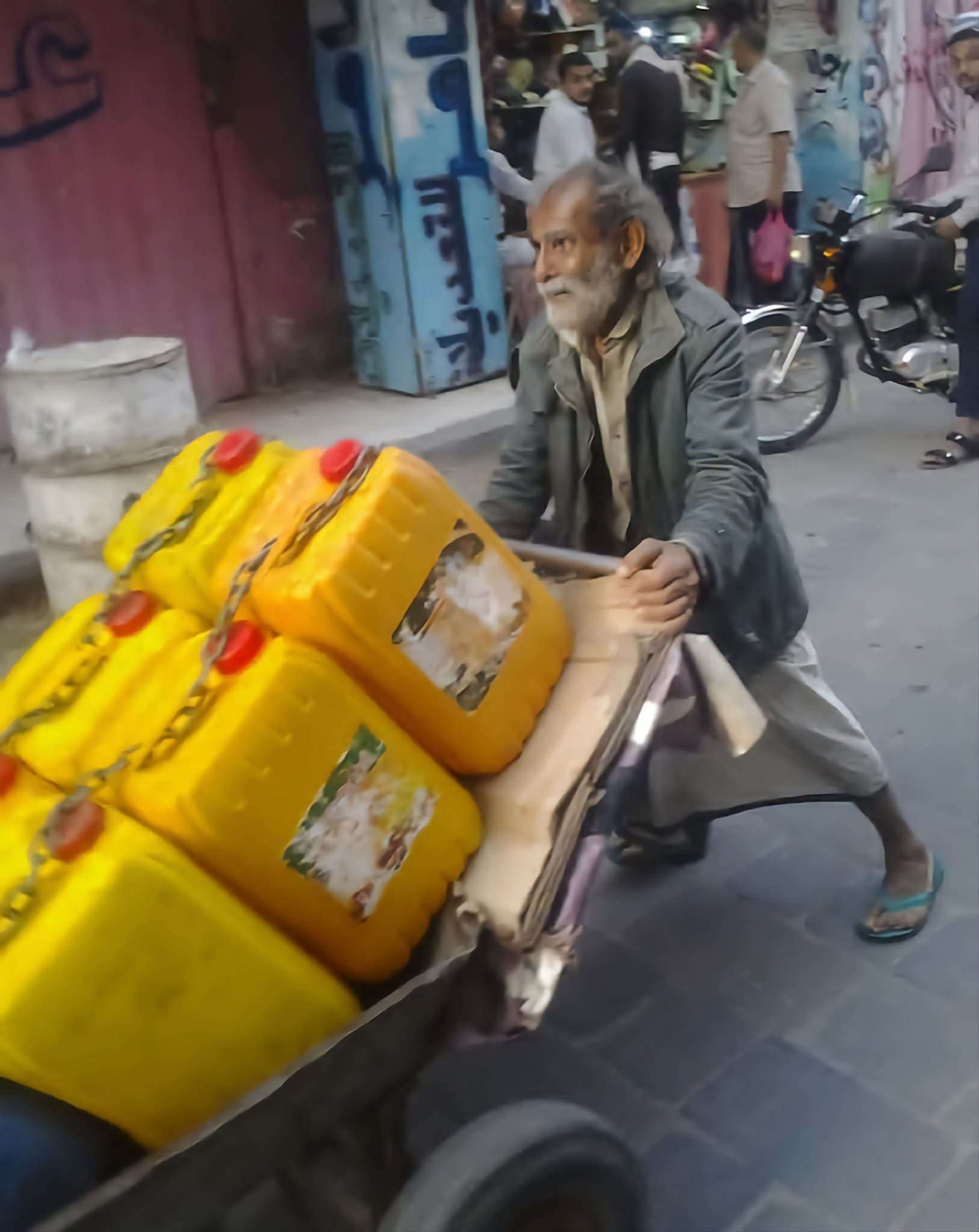 صورة تهز مشاعر اليمنيين.. مسن يجر عبوات المياه في شوارع تعز يجسد عمق الأزمة الإنسانية 1